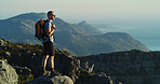 Hiking, travel and vacation with man on mountain for fitness, adventure and workout. Health, nature and exercise with person and outdoor view on cliff for trekking holiday, explore and mountains