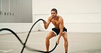 Fitness, man and battle ropes outdoor for core strength workout, power training and muscular endurance. Athlete, person and energy with exercise equipment for agility, health performance or challenge