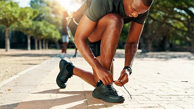 Buy stock photo Runner, black man and tie shoes in park for cardio training, running exercise or fitness workout. Begin, laces and footwear of African athlete on ground ready to start jog, race or marathon practice