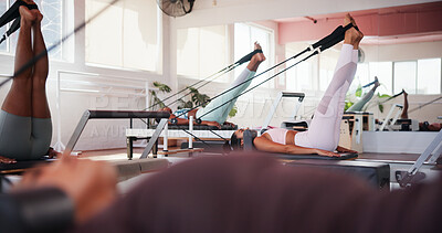 Buy stock photo Pilates, reformer and personal trainer with people in class for training, workout and exercise for mobility. Fitness, gym and women with machine for stretching legs for wellness, health or challenge