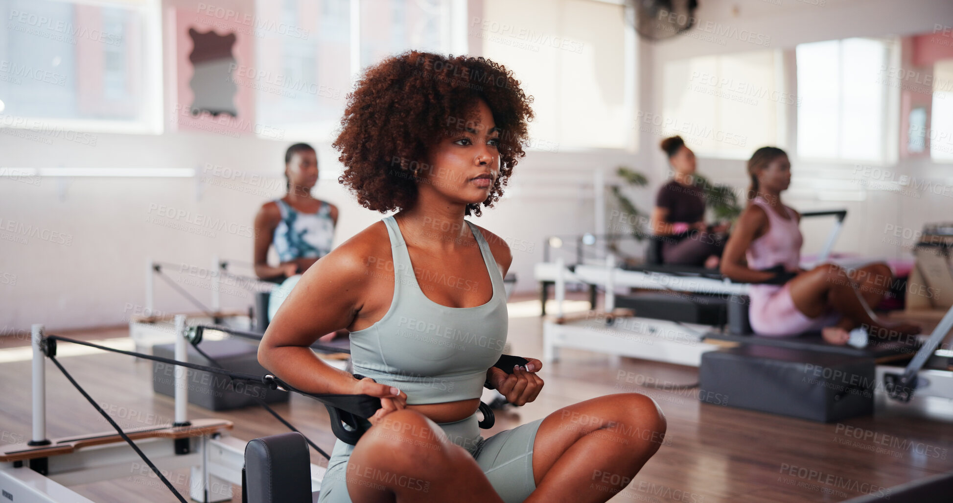 Buy stock photo Exercise, pilates and reformer with woman in gym for improvement, training or workout routine. Class, concentration and fitness with serious person on machine in studio for challenge or performance