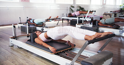 Buy stock photo Stretching, pilates and woman on machine in class for exercise, yoga workout and training. Personal trainer, gym and people on reformer equipment for health, wellness and fitness for core strength