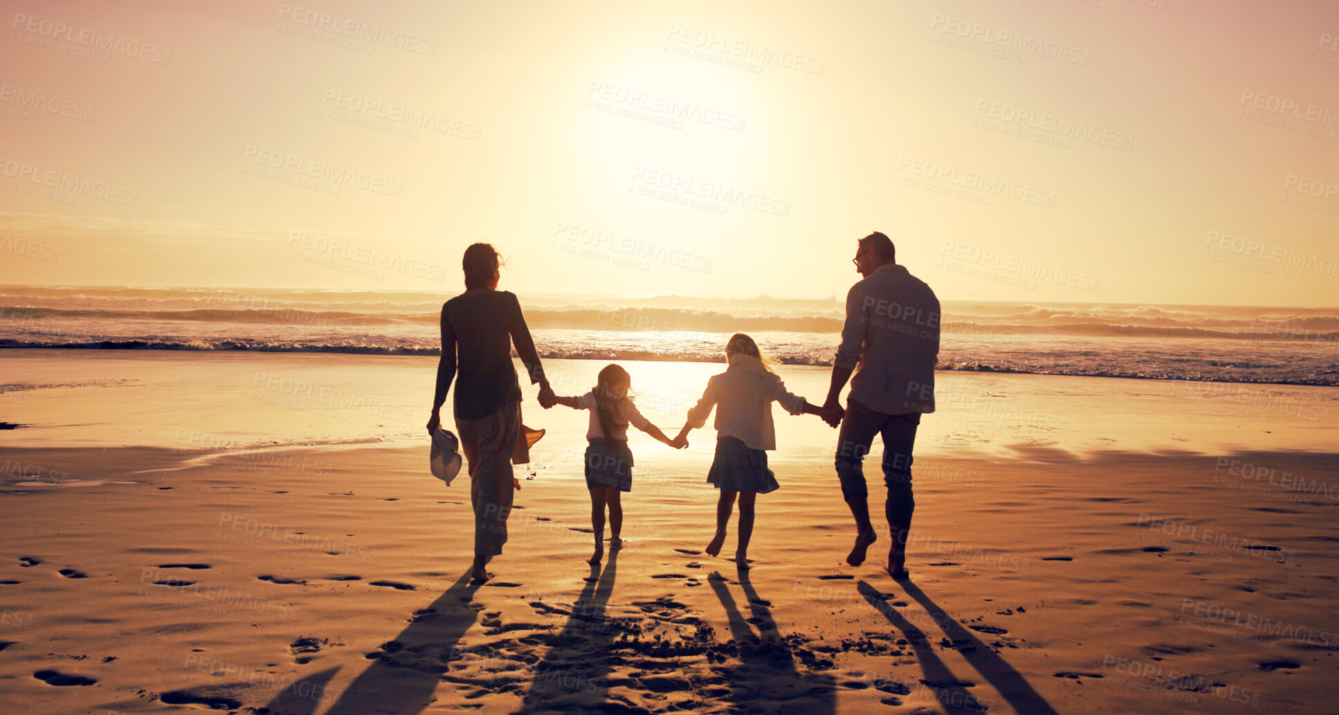 Buy stock photo Sunset, family and holding hands at beach for vacation, holiday and bonding together outdoor. Back, mother and father with children at ocean with mockup space, travel or summer adventure with parents