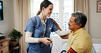 Senior man, nurse and blood pressure test in home, bedroom and happy with kindness for medical check. Elderly person, caregiver and smile for results, support and healthcare services in retirement