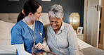Tablet, laughing and nurse with senior woman in bedroom for medical checkup with funny joke. Happy, bonding and healthcare worker with elderly female patient on bed with technology for treatment plan