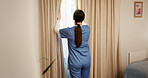 Curtain, opening and sunlight with nurse in hospital for start of morning routine as healthcare professional. Medical, view and window with person in ward of clinic for preparation from back