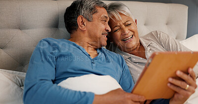 Buy stock photo Bedroom, senior couple and laughing with tablet for streaming comedy, reading news and entertainment. Old people, man and woman with smile for digital joke, funny video or bonding in morning at home