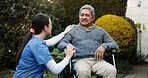 Assisted living, retirement or wheelchair with nurse and old man outdoor in garden for senior care. Conversation, health or wellness and caregiver speaking to person with disability in backyard