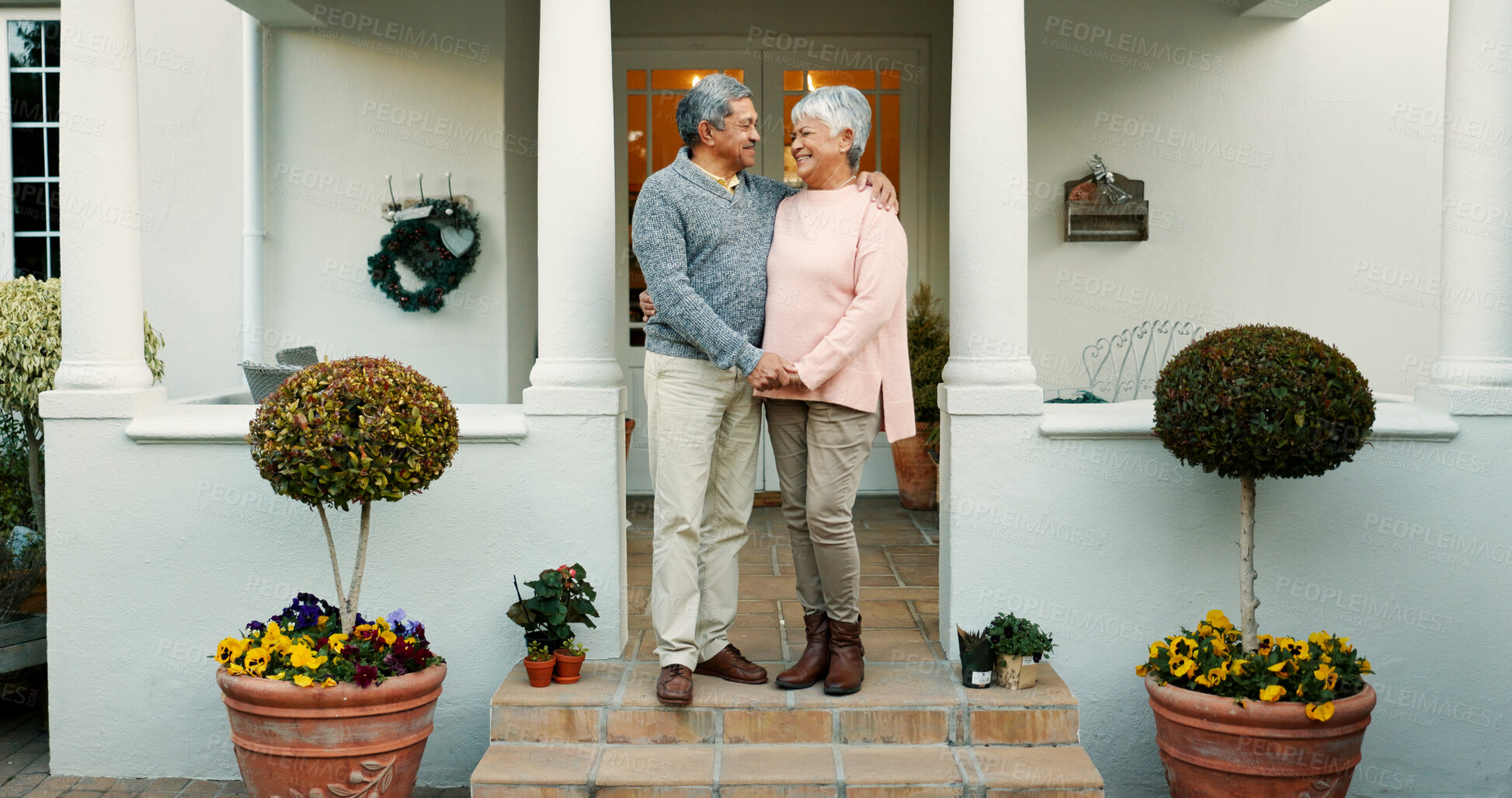 Buy stock photo Outdoor, home and senior couple with smile, hug and happy elderly people with mortgage and bonding. Holding hands, old woman and man with commitment to marriage, real estate and pride for new house