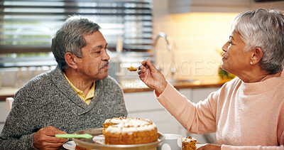 Buy stock photo Happy, couple and feeding cake for romance, love and senior people with commitment, care and marriage. Smile, old man and woman with dessert in kitchen, retirement and bonding with snack in house