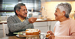 Love, couple and feeding cake for romance, happy and senior people with commitment, care and marriage. Smile, old man and woman with dessert in kitchen, retirement and bonding with snack in house