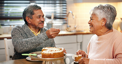 Buy stock photo Love, couple and feeding cake for romance, happy and senior people with commitment, care and marriage. Smile, old man and woman with dessert in kitchen, retirement and bonding with snack in house