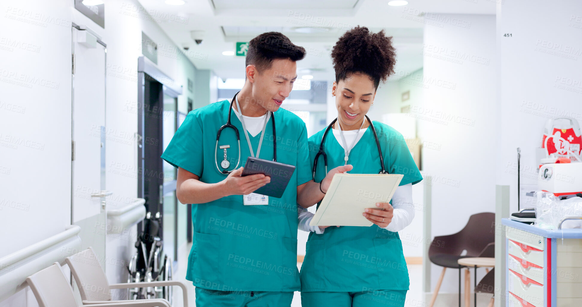 Buy stock photo Doctors, man and woman in hallway with tablet, documents and smile for results, report and feedback. People, team and happy with digital touchscreen, app and review with medical solution at hospital