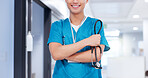 Happy, man and nurse with stethoscope in hospital for medical service or support. Crossed arms, confident and professional male healthcare worker with pride for career in hallway at nursing clinic.
