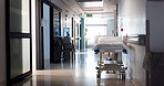 Healthcare, empty hospital and bed in hallway for service, medical care and health insurance. Community clinic, sterile and stretcher in corridor for help, rehabilitation facility and treatment ward