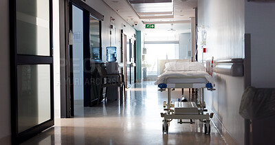 Buy stock photo Healthcare, empty hospital and bed in hallway for service, medical care and health insurance. Community clinic, sterile and stretcher in corridor for help, rehabilitation facility and treatment ward