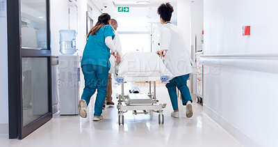 Buy stock photo Gurney, healthcare and rushing with doctors in hospital for emergency, operation or surgery. Medical, running and urgency with team of medicine professionals in hallway to save patient or victim