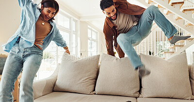 Buy stock photo Home, couple and happy with jump on sofa for fun game, bonding and relationship activity. Freedom, excited and people with energy on couch in living room for weekend break, support and entertainment