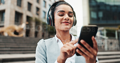 Buy stock photo Business woman, headphones and smartphone in city with commute, music and streaming sound on web. Person, phone and travel in town with audio, subscription and search for song on trip in Colombia