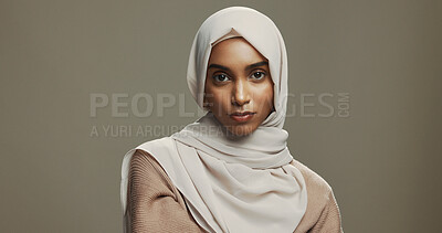 Buy stock photo Serious, beauty and portrait of woman with hijab in studio for Eid celebration with traditional islamic culture. Mockup space, fashion and muslim person with headscarf for ramadan on brown background