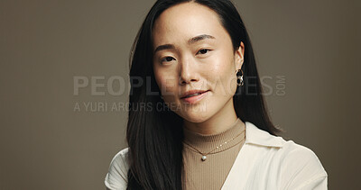Buy stock photo Fashion, studio and portrait of Asian woman for wellness, skincare or facial treatment. Beauty, mockup space and face of person with trendy jewellery for cosmetics, salon or shine on brown background