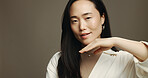 Skincare, beauty and portrait of Asian woman in studio with cosmetic, natural and facial routine. Glow, space and female person with face dermatology treatment for hydration by brown background.