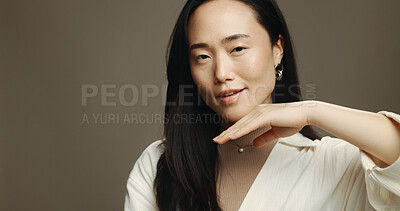 Buy stock photo Skincare, beauty and portrait of Asian woman in studio with cosmetic, natural and facial with mockup. Glow, space and female person with face dermatology treatment for hydration by brown background.