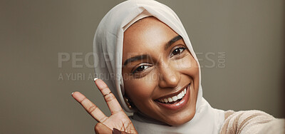 Buy stock photo Studio, selfie or woman with peace sign, hijab and smile for social media, live streaming POV or profile picture. Space, portrait or confident face of muslim girl on grey background for happy Ramadan