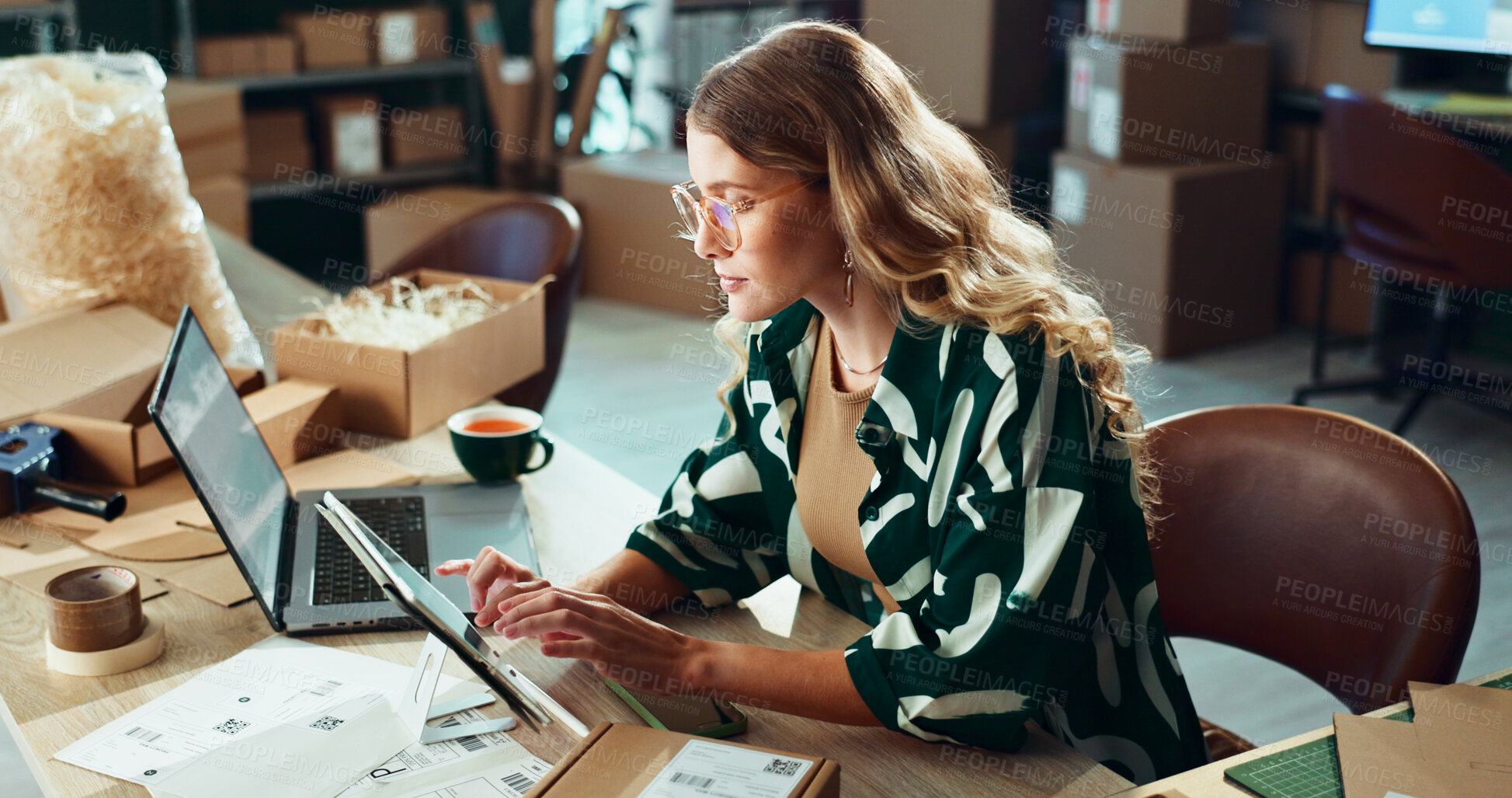 Buy stock photo Logistics, planning and tablet with woman in office for delivery or shipping schedule. Laptop, online order and supply chain with courier person at desk in depot or warehouse for ecommerce tracking