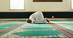 Islamic man, bow and prayer for religion, worship Allah or holy faith in mosque on Eid. Temple, muslim person or meditate for peace, hope or praise for spiritual gratitude on floor for dua on Ramadan