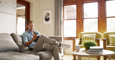 Buy stock photo Home, online shopping and man with card, tablet and browsing of digital products, lounge and website. House, customer and person with credit for purchase, relax and scrolling on app in living room