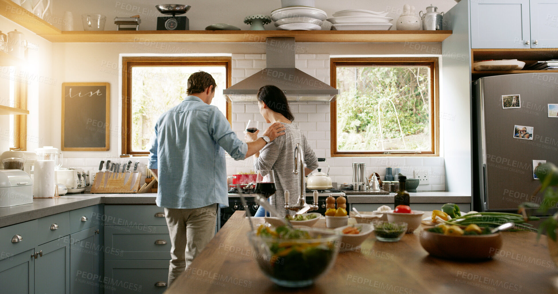 Buy stock photo Back, couple and cooking food in kitchen with organic ingredients, meal prepare and healthy lunch. People, wine and nutrition salad with vegetables, vegan diet and bonding of partner support at house