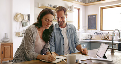 Buy stock photo Finance, notebook and couple in home for writing household budget, savings and taxes together. Tablet, financial and man helping woman with diary, investing or mortgage loan for planning in apartment