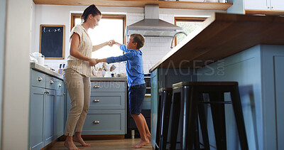 Buy stock photo Home, mother and child dancing in kitchen with holding hands, teaching steps or bonding together. Family, woman and boy kid with music for movement, learning and relationship with love, care or trust