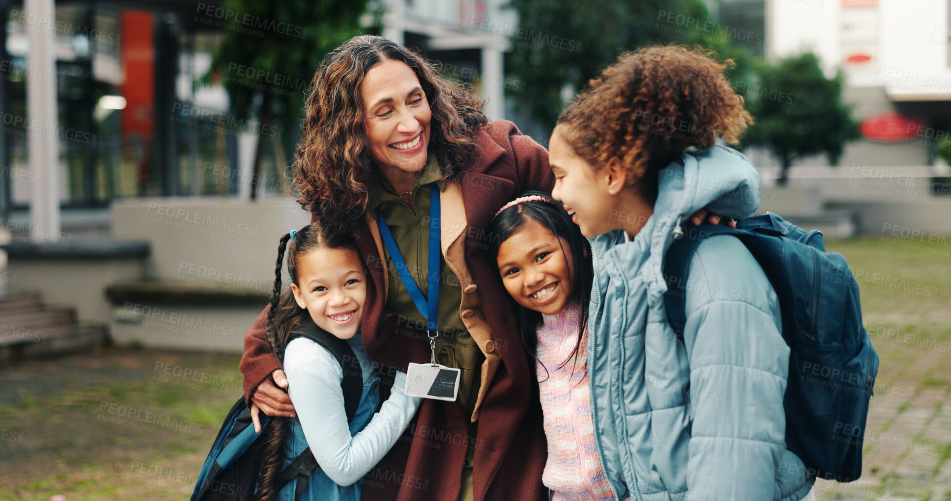 Buy stock photo School kids, hug and happy with teacher, outdoor and reunion in city for solidarity, connection or portrait. Children, group and woman with embrace, education and welcome for scholarship at academy
