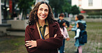 Happy, crossed arms and portrait of teacher at school with kids for education, learning and lesson. Educator, academy and woman with children for development, teaching or youth empowerment on campus