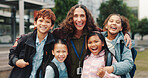 Children, hug and smile with teacher, outdoor and reunion in city for solidarity, connection or portrait. School kids, group and woman with embrace, education and welcome for scholarship at academy