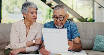 Buy stock photo Discussion, documents and senior couple on sofa with stress for debt, mortgage or bills repayment. Talk, upset and elderly man with woman for conversation on retirement funds with paperwork in home