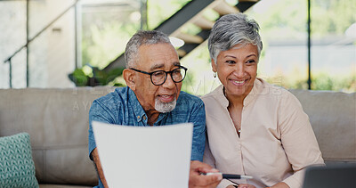 Buy stock photo Happy, documents and senior couple on sofa in discussion for debt, mortgage or bills payment completed. Excited, laptop and elderly man with woman for retirement funds plan with investment in home