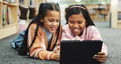 Buy stock photo Students, library and girls on carpet, tablet and online learning with education, knowledge and relax. Happy kids, children and friends on floor, tech or storytelling with ebook, break and smile