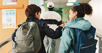 Buy stock photo Back, fist bump and friends in school corridor together for education, learning or study. Children, development or walking with boy and girl students in hallway for lesson, knowledge or scholarship