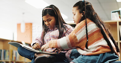 Buy stock photo Girl, friends and reading with story at library for development, learning and study with literature. School kids, book and help with scholarship, education and language with knowledge at academy