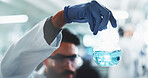 Chemical, hand and scientist with beaker in laboratory for medical vaccine development or study. Liquid, glass and male chemist working on pharmaceutical research, study or project with observation.