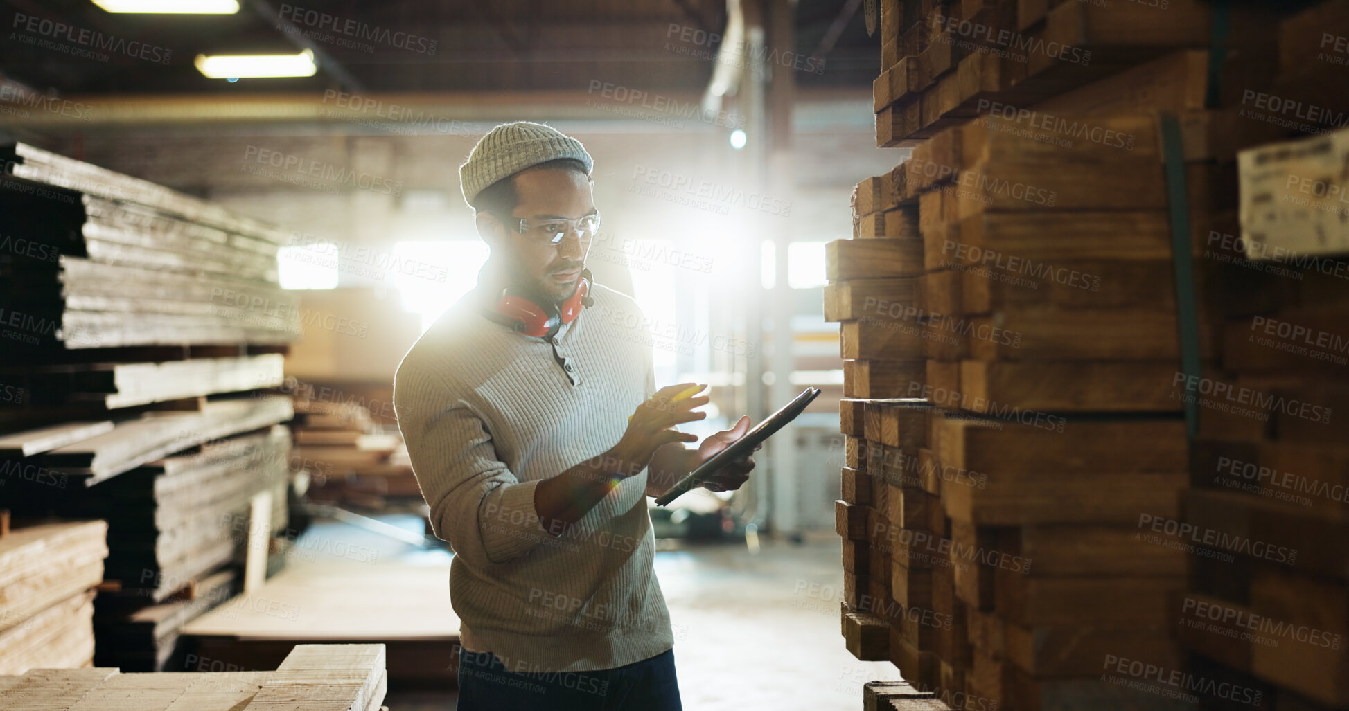 Buy stock photo Carpenter, tablet and wood inspection in workshop for inventory check, quality control or stock count. Manufacturing, man or digital checklist for timber management and material evaluation in storage