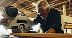 Carpenter, man and machine with wood in workshop, diy manufacturing and production business. Workshop, mature person and contractor with saw tools for furniture service, maintenance and cutting plank