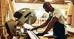 Carpenter, black man and machine with wood in workshop, diy manufacturing and production business. Factory, male person and contractor with saw tools for furniture service, maintenance and cut plank