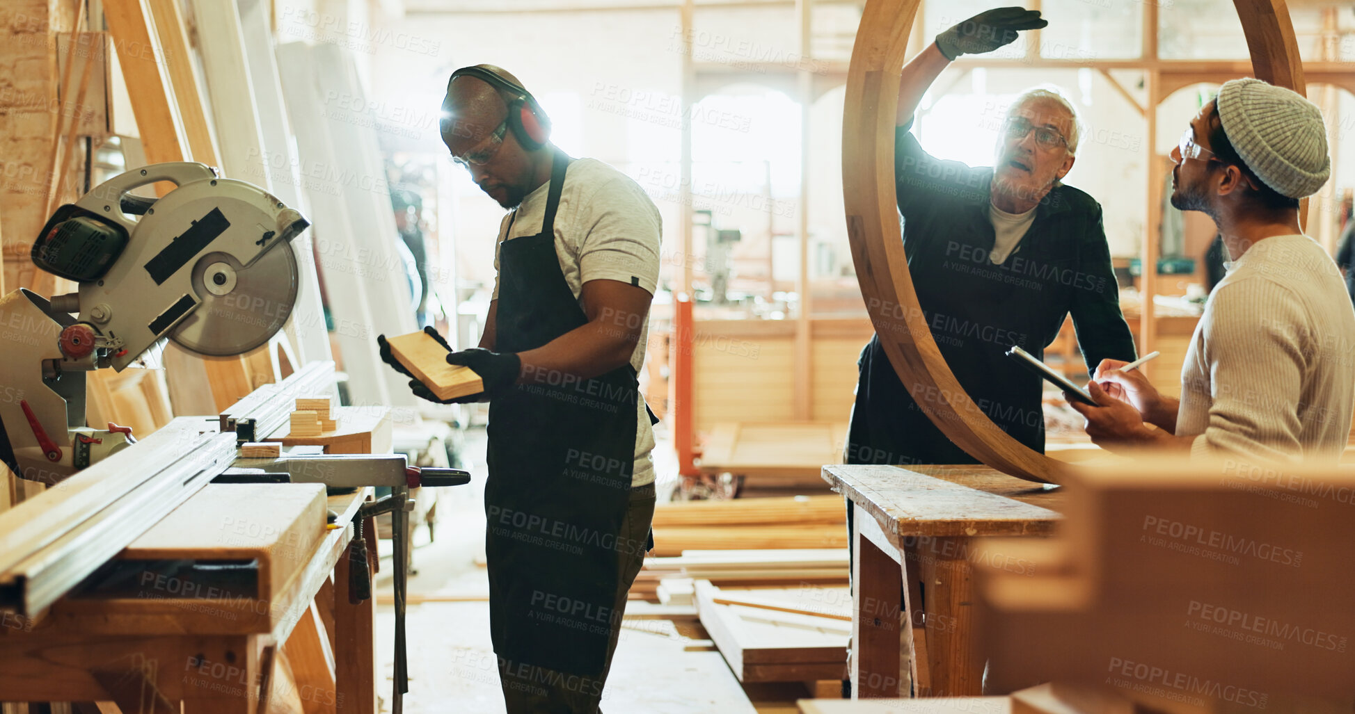 Buy stock photo Carpenter, men and teamwork for manufacturing, talking and helping intern with wood work and material. Warehouse, mature mentor and trainee with skills for craftsmanship, people and productivity