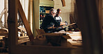 Carpenter, men and teamwork for manufacturing, furniture and helping intern with wood work and material. Warehouse, mature mentor and trainee with skills for craftsmanship, people and productivity