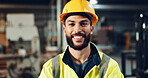 Engineer, man and happy with helmet at factory for manufacturing, industry and pride for career at workshop. Person, portrait or technician with ppe, smile and excited at production plant in Colombia
