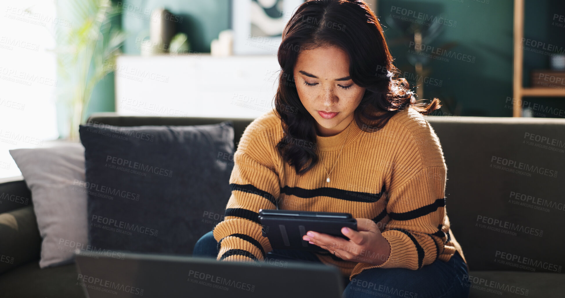 Buy stock photo Tablet, freelancer and woman in home with laptop for editing, review or journalist check story. Digital technology, serious and remote work with app for report, news and research article on internet